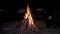 Closeup shot of a bonfire in the center of the tents in the camp