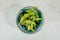 Closeup shot of a bowl of Edamame on a white table