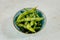 Closeup shot of a bowl of Edamame on a white table