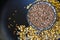 Closeup shot of a bowl of lentils and grains isolated on a dark surface