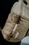 Closeup shot of brown camera utility bag with zippers, straps and backpack buckle