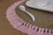 Closeup shot of a brown knit placemat with pink tassels