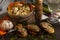 Closeup shot of bruschettas with chicken and a vegetable dish in a rustic straw bowl