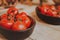 Closeup shot of a bunch of tomatoes in a black bowl