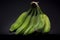 Closeup shot of a bunch of unripe green bananas with a black background