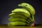 Closeup shot of a bunch of unripe green bananas with a black background