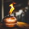 Closeup shot of a burning antique smudge pot on a wooden surface