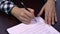 Closeup shot of a businesswoman signing the pages of a paper document or a contract - fake signature