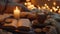 A closeup shot of a candlelit tray with a book propped open a mug of steaming tea and a plate of homemade cookies