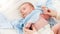 Closeup shot of caring mother undressing her little 1 months old baby boy lying on changing table. Concept of babies and
