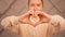 Closeup shot of a caucasian female forming a heart sign with her hands