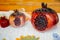 Closeup shot of ceramic pomegranate figures on a white cloth surface