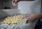 Closeup shot of a chef preparing potato gnocchi with flour