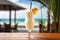 Closeup Shot Of Chilled Alcoholic Pina Colada Cocktail, Garnished With Cream And Pineapple, With Tro