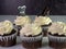 Closeup shot of chocolate cupcakes with white cream and dotted dress and shoe pins