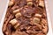 Closeup shot of chocolate ice cream topped with white pieces of chocolates  in a steel container