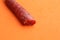 Closeup shot of chorizo sausage on an orange background