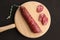 Closeup shot of chorizo sausage on wooden chopping board on black background