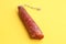 Closeup shot of the chorizo sausage on a yellow background