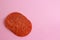 Closeup shot of chorizo slices from pamplona on a pink surface