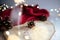 Closeup shot of Christmas tree bumps, lights, and red fabric on a table