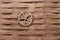 Closeup shot of a circular wooden object with spikes on a brown surface