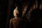 Closeup shot of a clay religious Buddha statue in a creepy mysterious place