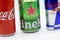 a closeup shot of a coca cola can, a heineken can and a redbull can on a white background