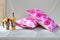 Closeup shot of colorful pillows, a vase and a candle holder bottle on a cloth background