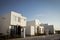 Closeup shot of a complex of white and brown modern building blocks with sunshine