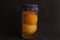 Closeup shot of a container with homemade apricot jam on a black background