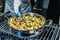 Closeup shot of the cook preparing a dish with vegetables in a metal cooker