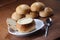 Closeup shot of creamy clams served in bread dough and spoon on a smooth surface