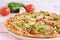 Closeup shot of a crusty pizza with chicken and green peppers