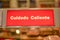 Closeup shot of Cuidado Caliente text with a bokeh background