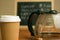 Closeup shot of a cup of coffee and a teapot on the table