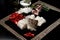 Closeup shot of cut-up fish, peppers, garlic, onion on a cutting board near salt and oil