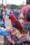 Closeup shot of a cute exotic Macaw parrot hanging out in the middle of the city