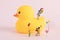 Closeup shot of cute figurines playing with balloons playing on a rubber duck