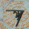 Closeup shot of a decorated old sun clock, compass, and calendar with golden numbers