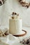 Closeup shot of delicious Boho ombre cake with dry flowers on a white table