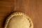 Closeup shot of a delicious empanada isolated on a wooden surface