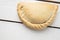 Closeup shot of a delicious empanada on a wooden surface