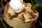 Closeup shot of a delicious English apple pie with a scoop of vanilla ice cream on top