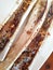 Closeup shot of delicious pair of bone marrow topped with fried garlic.