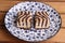 Closeup shot of delicious square biscuits with chocolate cream on a decorative plate