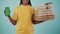 Closeup shot. Delivery woman in uniform holding stack of pizza boxes with coffee and smartphone. Advertising area