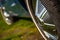 Closeup shot of details on the rims of a vintage blue Ford Mustang sports car