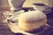 Closeup shot of donut with cup of tea on table in old-fashioned