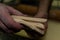 Closeup shot of dough triangles in a baker\'s hand for making croissants in a bakery